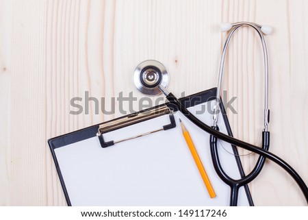 Doctor stethoscope, clipboard with paper blank, pencil