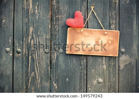 Sign board, love heart, hanging on vintage wood background