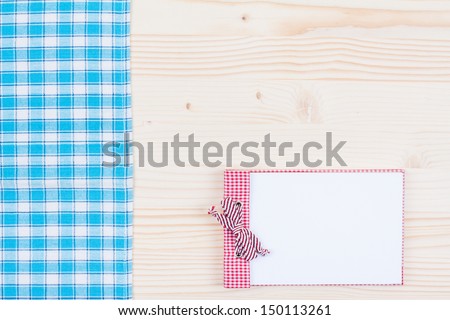 Wood texture background with recipe cookbook, red and white tablecloth