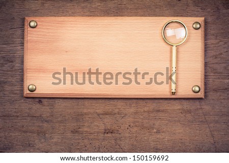 Detective office signboard with magnifying glass on old wood background