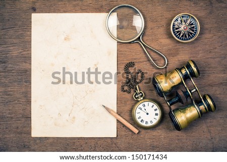 Vintage Paper For Map, Old Binoculars, Compass, Pocket Watch,Pencil, Rope, Magnifying Glass On Wooden Background