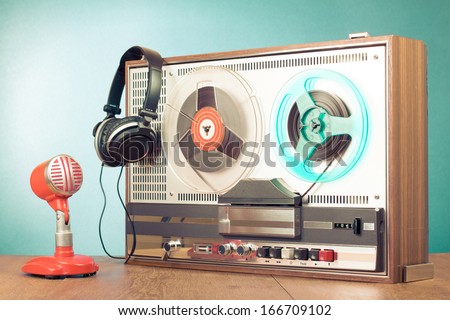 Retro reel to reel tape recorder microphone headphones in front mint green background Retro reel to reel tape recorder microphone headphones in front mint green background