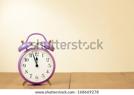 Retro clock with five minutes to twelve o\'clock