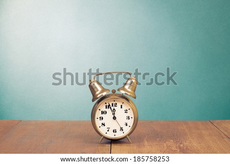 Retro alarm clock with five minutes to twelve o\'clock