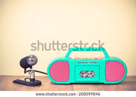 Retro radio cassette recorder, old microphone on table