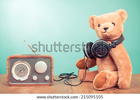 Retro toy Teddy Bear and radio receiver front mint green background
