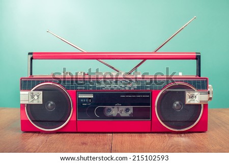 Retro red radio cassette stereo tape recorder front mint green background