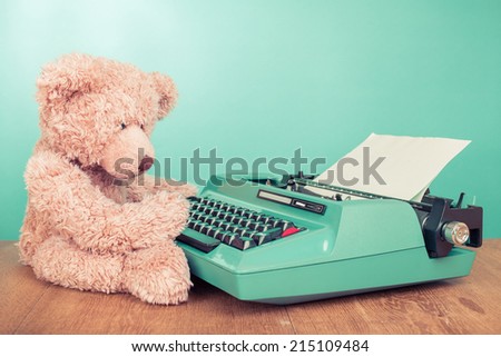 Teddy Bear toy with retro mint green retro typewriter on table concept