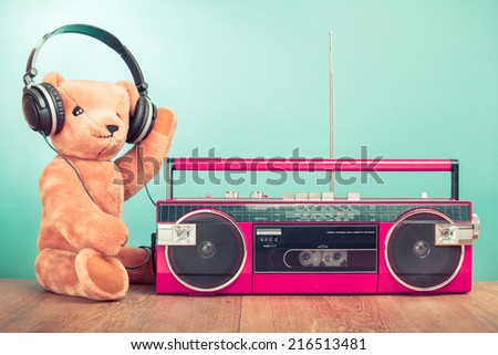 Teddy Bear with headphones, retro radio recorder front mint green background