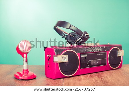 Retro radio recorder, microphone and headphones front mint green background