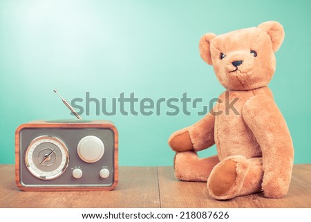 Vintage Teddy Bear and retro radio front mint green wall background