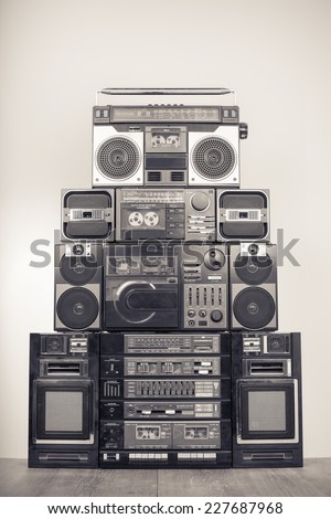 Retro big radio cassette and disk recorders from 80s. Vintage old style sepia greyscale photo