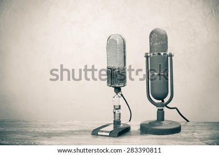 Old retro big ribbon microphones from 50s on table. Vintage style sepia photo