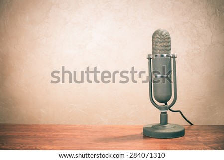 Retro old microphone for broadcasting or recording from 50s on table Vintage instagram style filtered photo Retro old microphone for broadcasting or recording from 50s on table Vintage instagram style filtered photo