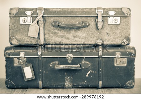 Retro old classic big travel leather valises. Vintage style sepia photo