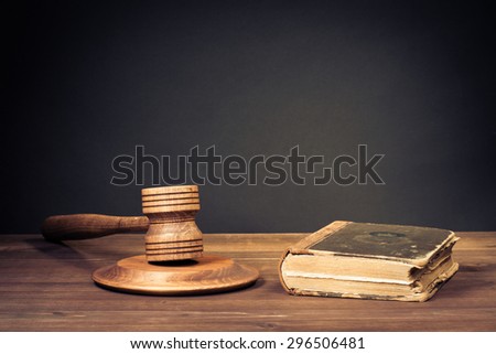 Judge gavel and law book. Symbol of justice. Old style filtered photo