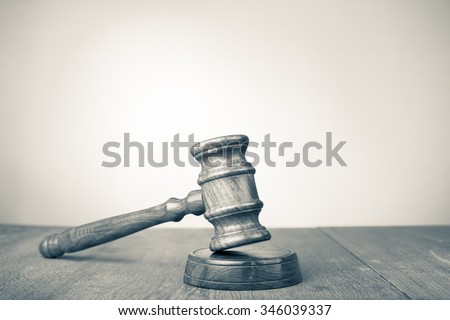 Judge gavel on table. Symbol of justice. Retro style sepia photo