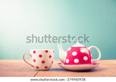 Cup of tea and teapot with polka dots. Retro style filtered photo