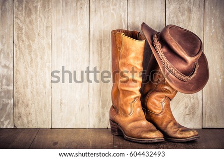 Wild West retro leather cowboy hat and old boots. Vintage style filtered photo