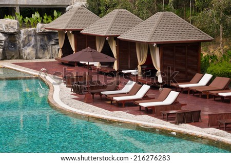 Beautiful Swimming Pool, Chair and Hut in tropical resort