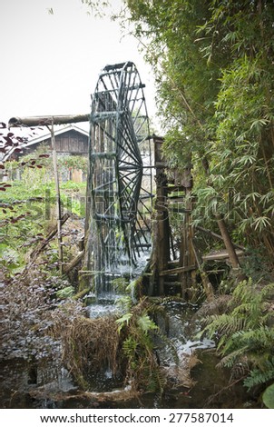 Old village water mill and water wheel - Water mill and wooden water wheel at Guilin Village, China