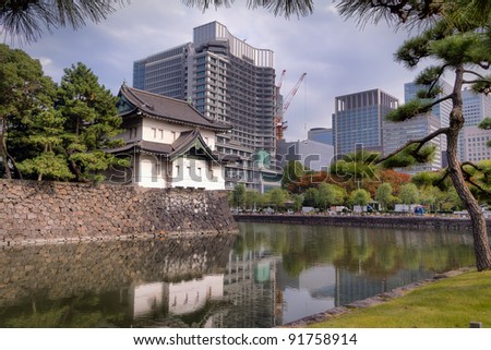 One of the towers of the imperial palace grounds with modern Tokyo growing around it