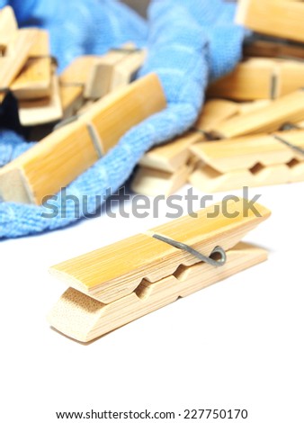 Wooden clothes pin and laundered denim fabric isolated on white background