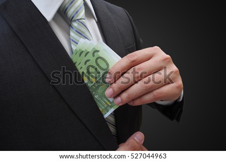 Businessman putting euro banknotes in suit pocket, bribe and corruption concept.