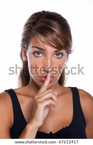 An attractive nice young woman puts her finger to her lips as if to say \
