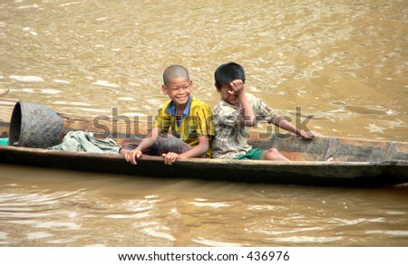 A happy & unhappy Kid in a boat Myanmar (Burma)