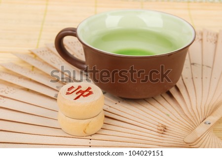 Tea,chinese fan with chess on bamboo tray