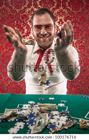 A man wearing glasses, a white shirt, and a red Texas tie sits at a blackjack table. He smiles as he tosses his winnings in the air./Smiling Man Wins Big Money at Blackjack