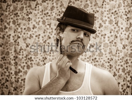 Vintage young white man in brown hat tank top mustache shaves stubble straight razor sepia tone