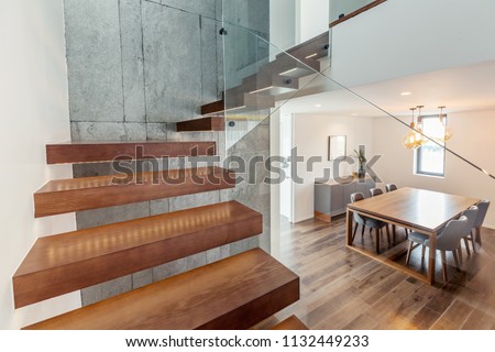 Living room modern interior design with stairs, grey colours, white walls