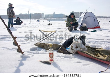 NOVOSIBIRSK, RUSSIA - MARCH 26: Men engaged in winter fishing on the Ob Sea in Siberia. Russian men are very fond of ice fishing, March 26, 2009 in the Novosibirsk, Russia