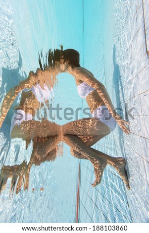 Beautiful girl is under water, no face, no mask concept