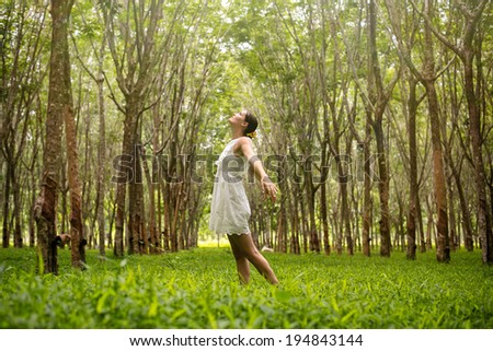 Beautiful romantic woman happy in the forest