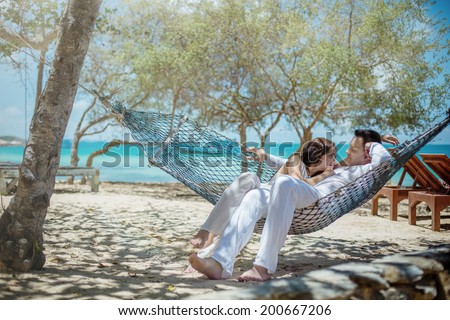 Love couple in a hammock at the beach