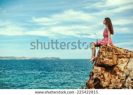 Beautiful woman on the cliff and sea, freedom concept