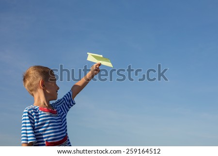 boy playing with paper airplane