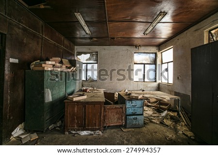 Old furniture and books in abandoned factory building
