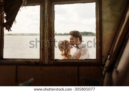 Beautiful Love Wedding Couple Kissing Outside the Window of Old Ship