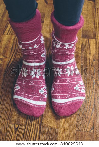 Feet in warm socks on Wooden Floor