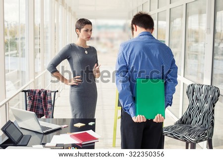 Angry female boss talking to worker male in office. Business woman. Critical situation, problem, management