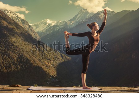 Young woman doing yoga in mountains outdoor. Morning Fitness, Yoga tours