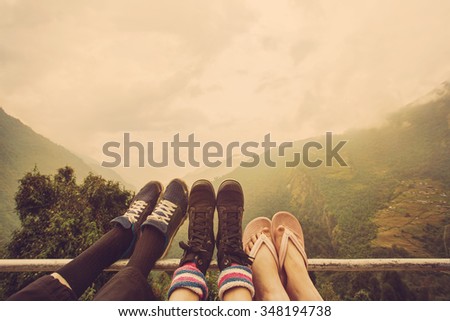 Friends legs outdoor on mountain background. Travel together