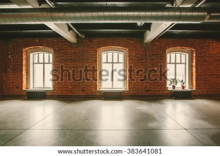 Loft studio Interior in old house. Big windows, brick red wall
