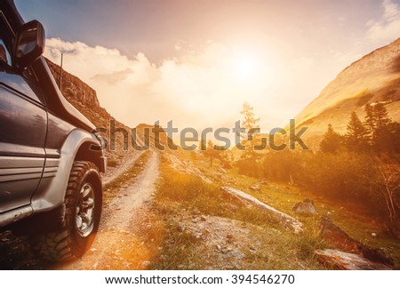 Off-road travel on mountain road. Beautiful mountains sunset