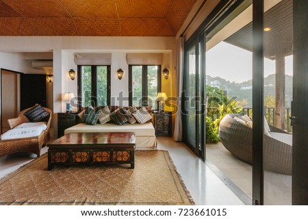 Tropical luxury villa interior, living room with sea view veranda