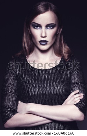 Closeup portrait of a serious lady with smoky eye makeup